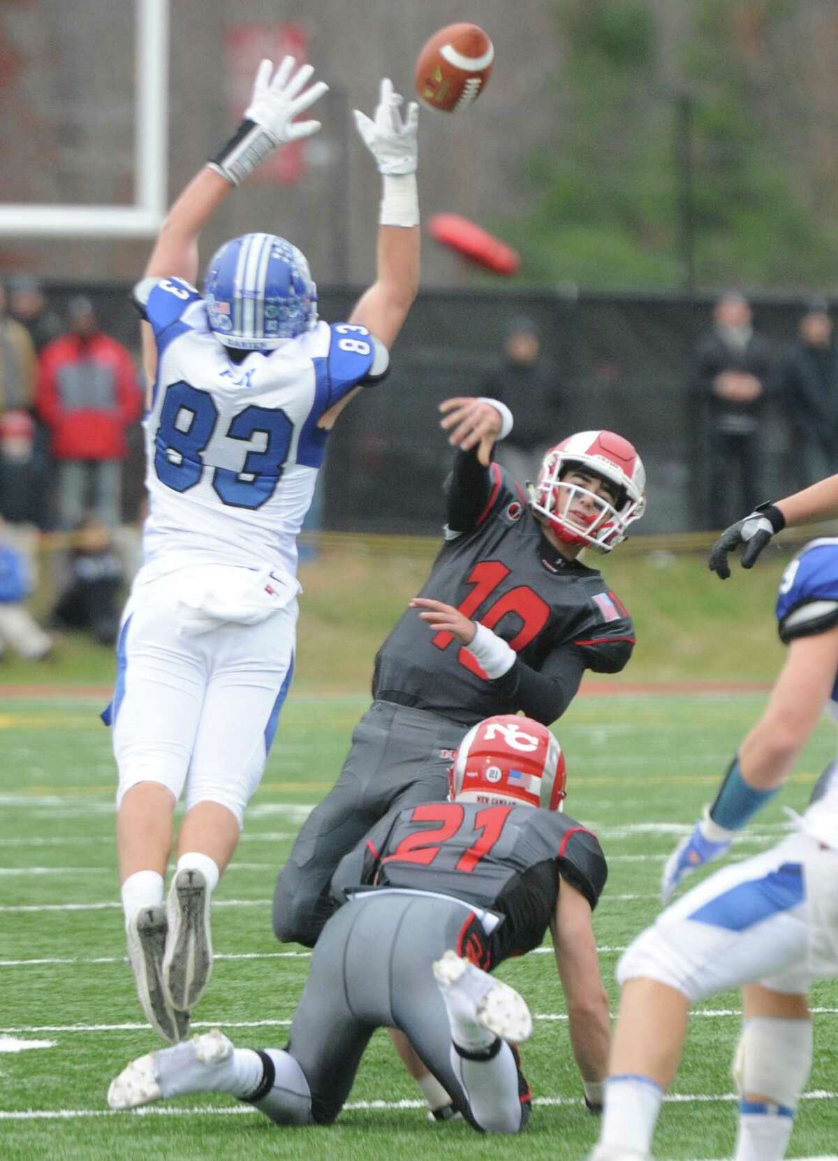 Photos from Darien's 37-34 win over New Canaan in the Turkey Bowl high school football game at Dunning Stadium in New Canaan, Conn. Thursday, Nov. 24, 2016. New Canaan scored 24 unanswered points to tie the game and force an overtime. In overtime, Darien kicked a field goal to take the lead and forced a New Canaan interception to end the game, setting off a wild celebration as fans stormed the field.