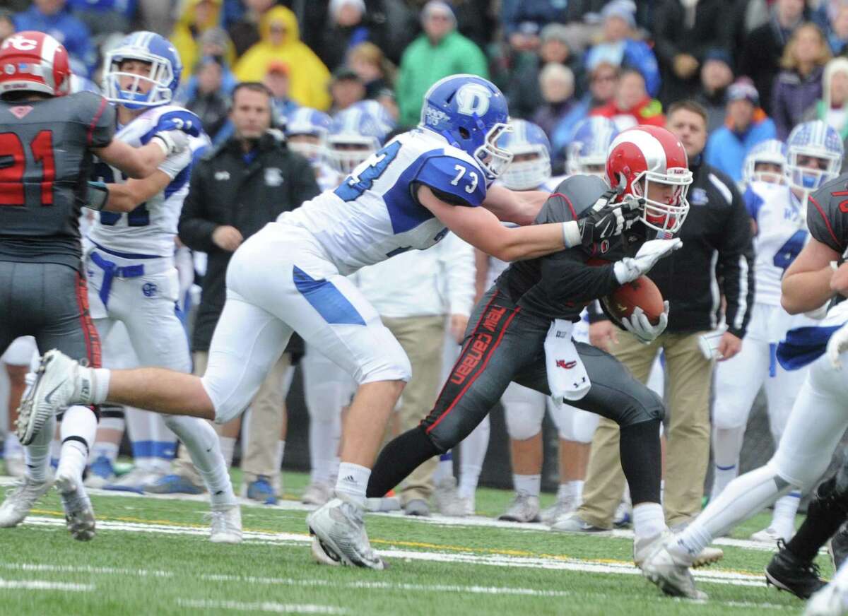 Photos from Darien's 37-34 win over New Canaan in the Turkey Bowl high school football game at Dunning Stadium in New Canaan, Conn. Thursday, Nov. 24, 2016. New Canaan scored 24 unanswered points to tie the game and force an overtime. In overtime, Darien kicked a field goal to take the lead and forced a New Canaan interception to end the game, setting off a wild celebration as fans stormed the field.