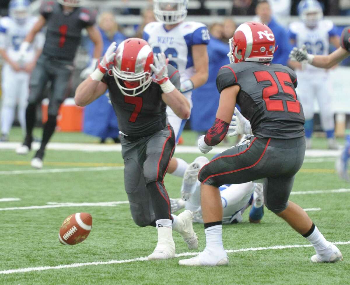 Photos from Darien's 37-34 win over New Canaan in the Turkey Bowl high school football game at Dunning Stadium in New Canaan, Conn. Thursday, Nov. 24, 2016. New Canaan scored 24 unanswered points to tie the game and force an overtime. In overtime, Darien kicked a field goal to take the lead and forced a New Canaan interception to end the game, setting off a wild celebration as fans stormed the field.