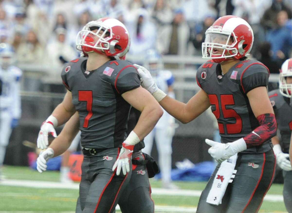 Photos from Darien's 37-34 win over New Canaan in the Turkey Bowl high school football game at Dunning Stadium in New Canaan, Conn. Thursday, Nov. 24, 2016. New Canaan scored 24 unanswered points to tie the game and force an overtime. In overtime, Darien kicked a field goal to take the lead and forced a New Canaan interception to end the game, setting off a wild celebration as fans stormed the field.