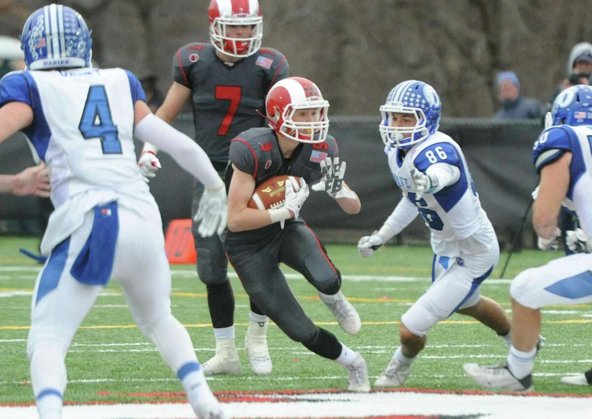 Photos from Darien's 37-34 win over New Canaan in the Turkey Bowl high school football game at Dunning Stadium in New Canaan, Conn. Thursday, Nov. 24, 2016. New Canaan scored 24 unanswered points to tie the game and force an overtime. In overtime, Darien kicked a field goal to take the lead and forced a New Canaan interception to end the game, setting off a wild celebration as fans stormed the field.