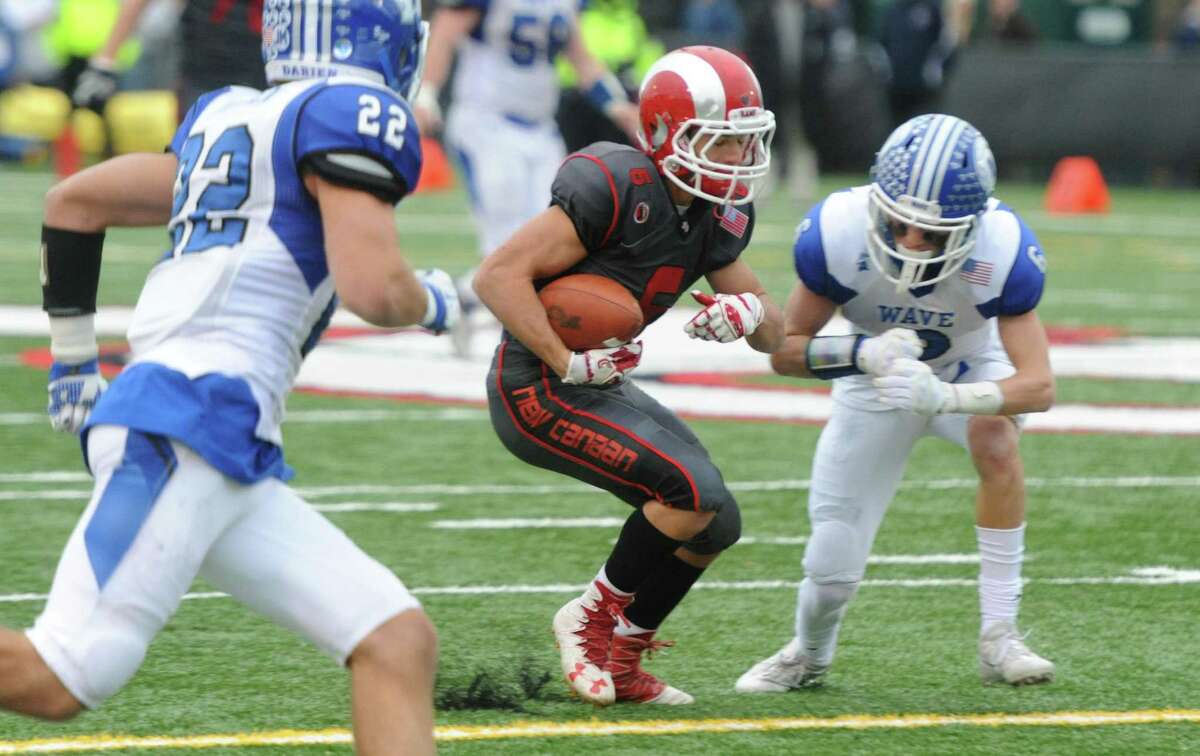 Photos from Darien's 37-34 win over New Canaan in the Turkey Bowl high school football game at Dunning Stadium in New Canaan, Conn. Thursday, Nov. 24, 2016. New Canaan scored 24 unanswered points to tie the game and force an overtime. In overtime, Darien kicked a field goal to take the lead and forced a New Canaan interception to end the game, setting off a wild celebration as fans stormed the field.