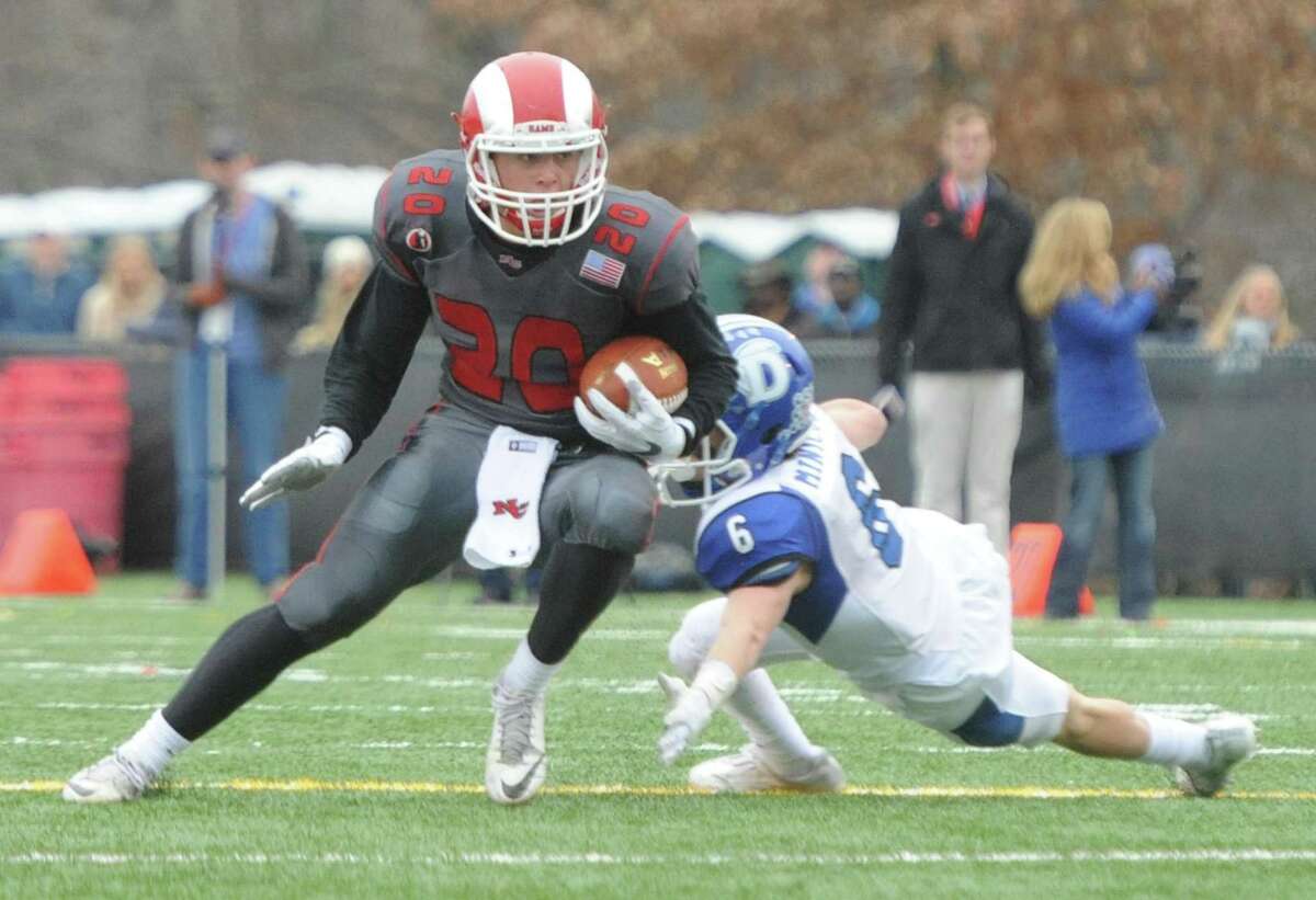 Photos from Darien's 37-34 win over New Canaan in the Turkey Bowl high school football game at Dunning Stadium in New Canaan, Conn. Thursday, Nov. 24, 2016. New Canaan scored 24 unanswered points to tie the game and force an overtime. In overtime, Darien kicked a field goal to take the lead and forced a New Canaan interception to end the game, setting off a wild celebration as fans stormed the field.