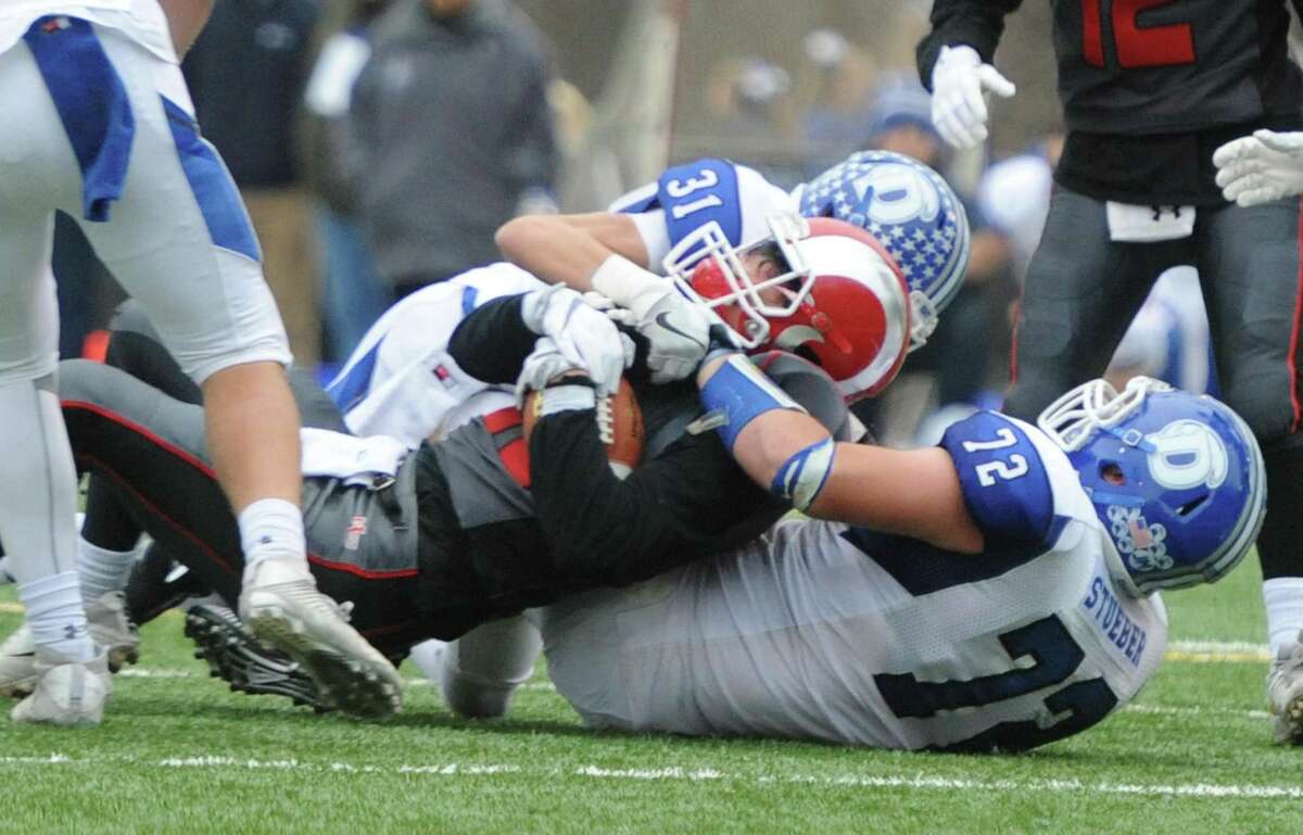 Photos from Darien's 37-34 win over New Canaan in the Turkey Bowl high school football game at Dunning Stadium in New Canaan, Conn. Thursday, Nov. 24, 2016. New Canaan scored 24 unanswered points to tie the game and force an overtime. In overtime, Darien kicked a field goal to take the lead and forced a New Canaan interception to end the game, setting off a wild celebration as fans stormed the field.