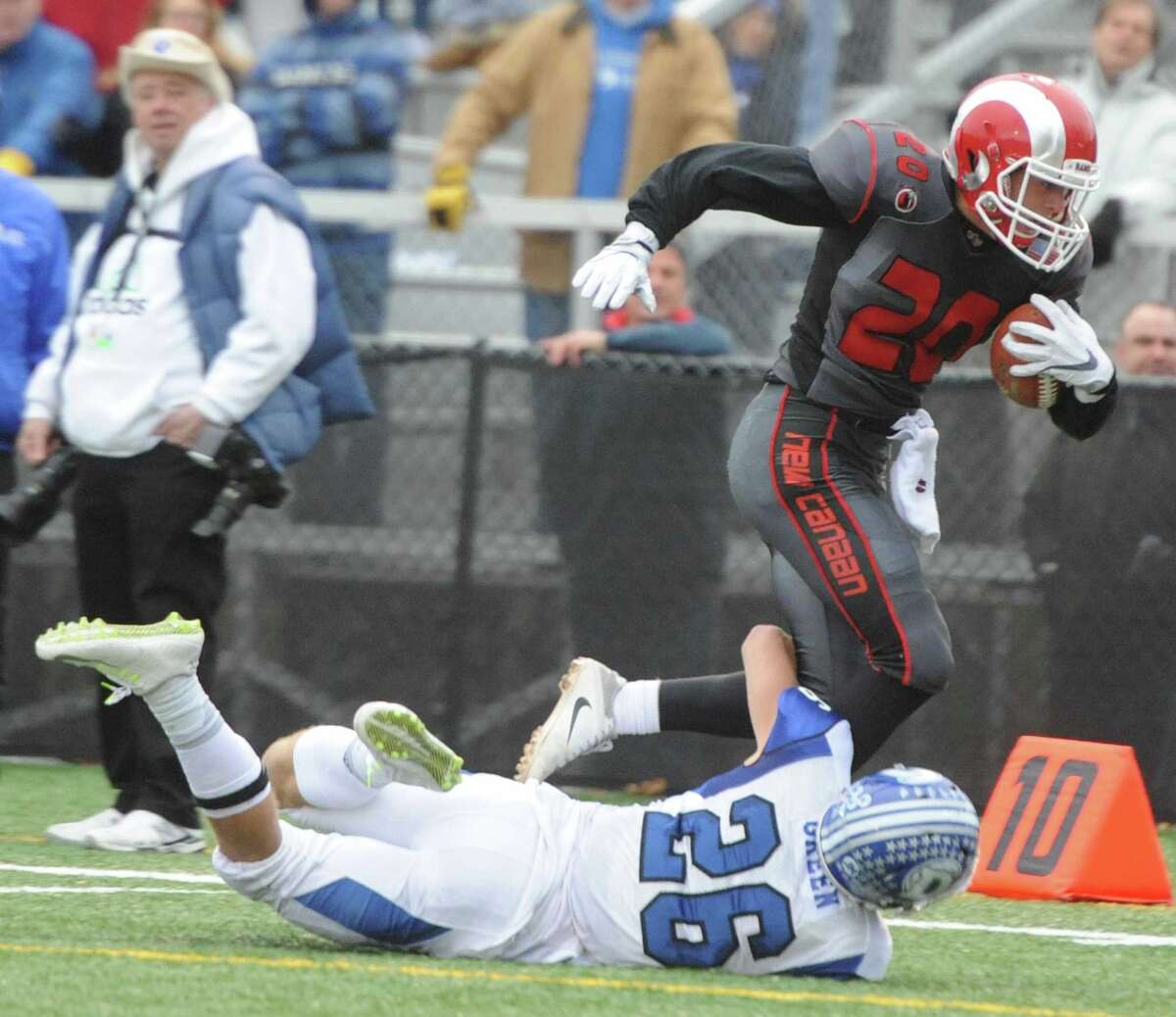 Photos from Darien's 37-34 win over New Canaan in the Turkey Bowl high school football game at Dunning Stadium in New Canaan, Conn. Thursday, Nov. 24, 2016. New Canaan scored 24 unanswered points to tie the game and force an overtime. In overtime, Darien kicked a field goal to take the lead and forced a New Canaan interception to end the game, setting off a wild celebration as fans stormed the field.