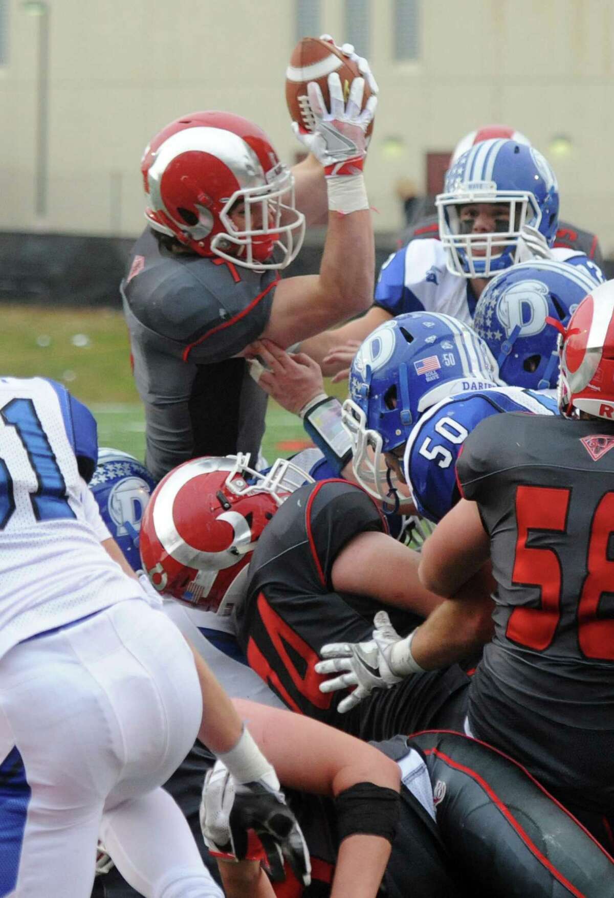 Photos from Darien's 37-34 win over New Canaan in the Turkey Bowl high school football game at Dunning Stadium in New Canaan, Conn. Thursday, Nov. 24, 2016. New Canaan scored 24 unanswered points to tie the game and force an overtime. In overtime, Darien kicked a field goal to take the lead and forced a New Canaan interception to end the game, setting off a wild celebration as fans stormed the field.