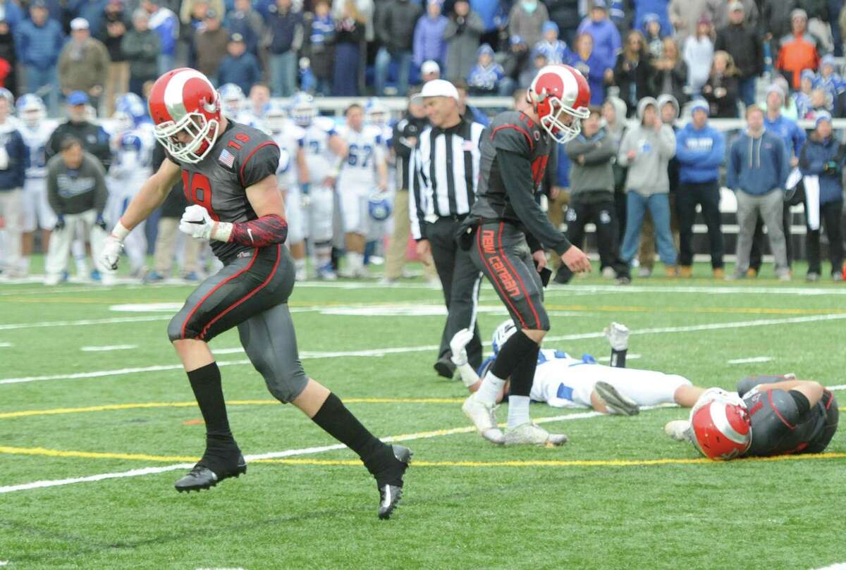 Photos from Darien's 37-34 win over New Canaan in the Turkey Bowl high school football game at Dunning Stadium in New Canaan, Conn. Thursday, Nov. 24, 2016. New Canaan scored 24 unanswered points to tie the game and force an overtime. In overtime, Darien kicked a field goal to take the lead and forced a New Canaan interception to end the game, setting off a wild celebration as fans stormed the field.