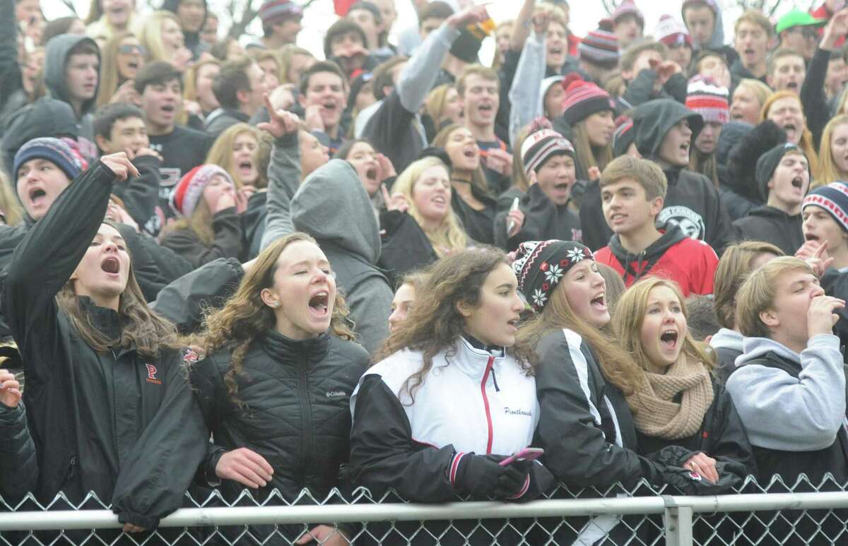 Photos from Darien's 37-34 win over New Canaan in the Turkey Bowl high school football game at Dunning Stadium in New Canaan, Conn. Thursday, Nov. 24, 2016. New Canaan scored 24 unanswered points to tie the game and force an overtime. In overtime, Darien kicked a field goal to take the lead and forced a New Canaan interception to end the game, setting off a wild celebration as fans stormed the field.