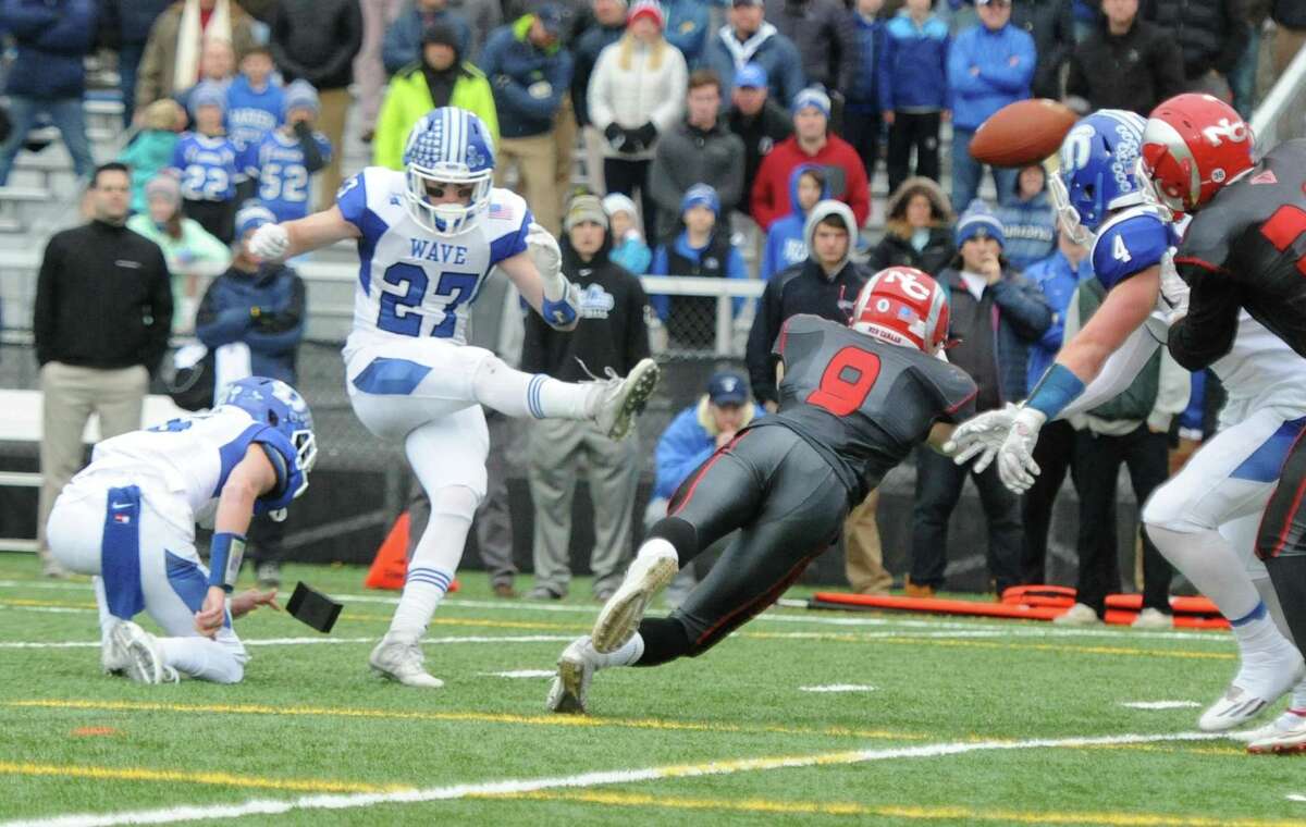 Photos from Darien's 37-34 win over New Canaan in the Turkey Bowl high school football game at Dunning Stadium in New Canaan, Conn. Thursday, Nov. 24, 2016. New Canaan scored 24 unanswered points to tie the game and force an overtime. In overtime, Darien kicked a field goal to take the lead and forced a New Canaan interception to end the game, setting off a wild celebration as fans stormed the field.