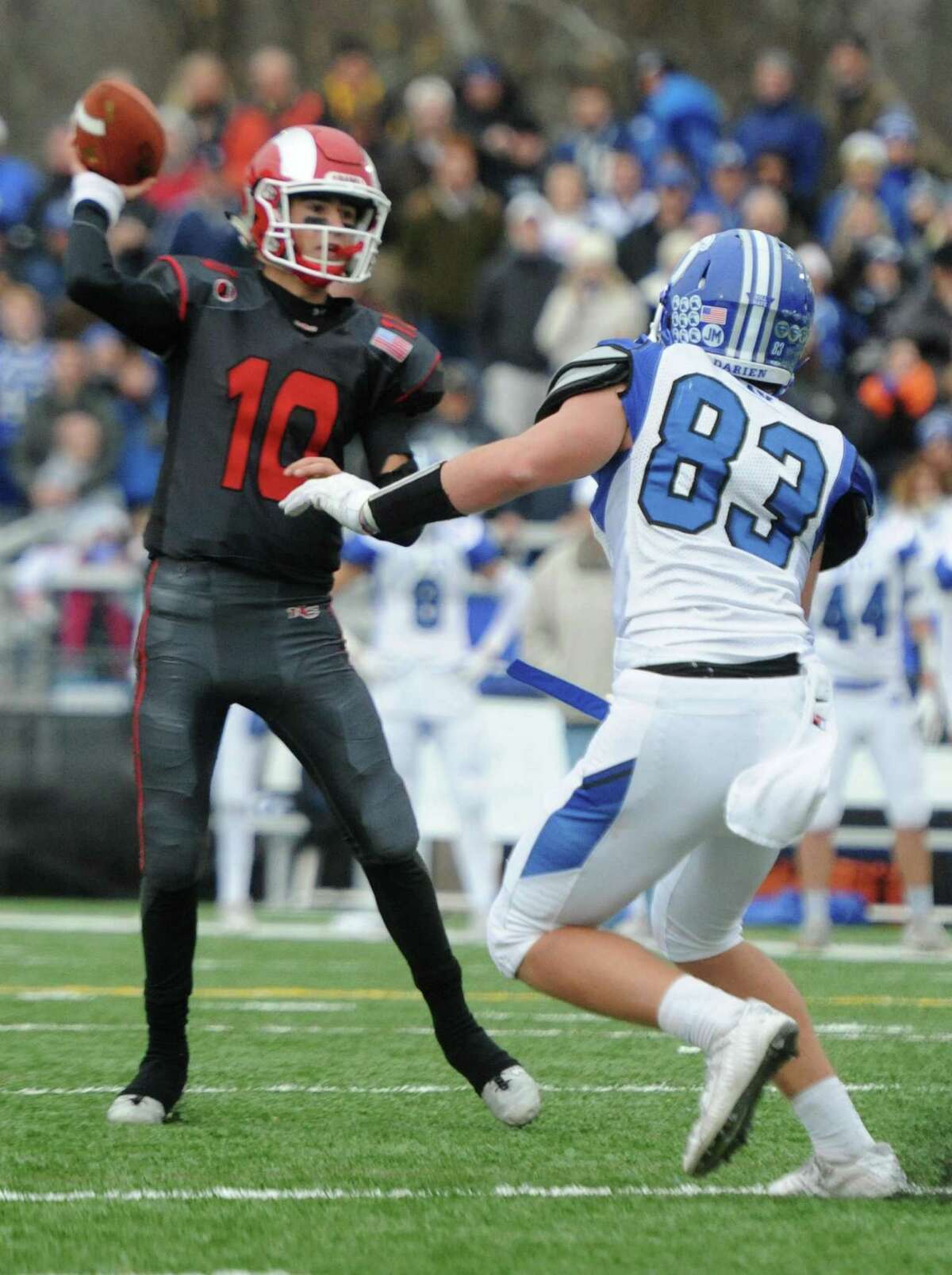 Photos from Darien's 37-34 win over New Canaan in the Turkey Bowl high school football game at Dunning Stadium in New Canaan, Conn. Thursday, Nov. 24, 2016. New Canaan scored 24 unanswered points to tie the game and force an overtime. In overtime, Darien kicked a field goal to take the lead and forced a New Canaan interception to end the game, setting off a wild celebration as fans stormed the field.