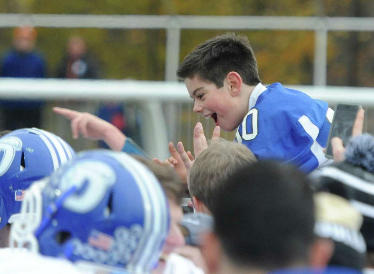 Photos from Darien's 37-34 win over New Canaan in the Turkey Bowl high school football game at Dunning Stadium in New Canaan, Conn. Thursday, Nov. 24, 2016. New Canaan scored 24 unanswered points to tie the game and force an overtime. In overtime, Darien kicked a field goal to take the lead and forced a New Canaan interception to end the game, setting off a wild celebration as fans stormed the field.