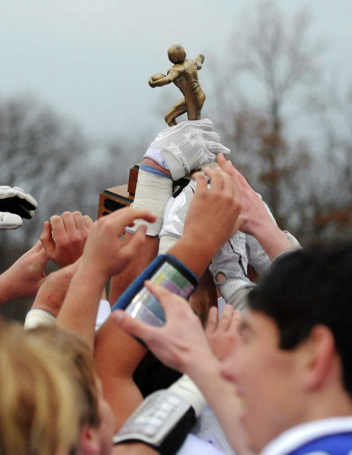 Photos from Darien's 37-34 win over New Canaan in the Turkey Bowl high school football game at Dunning Stadium in New Canaan, Conn. Thursday, Nov. 24, 2016. New Canaan scored 24 unanswered points to tie the game and force an overtime. In overtime, Darien kicked a field goal to take the lead and forced a New Canaan interception to end the game, setting off a wild celebration as fans stormed the field.