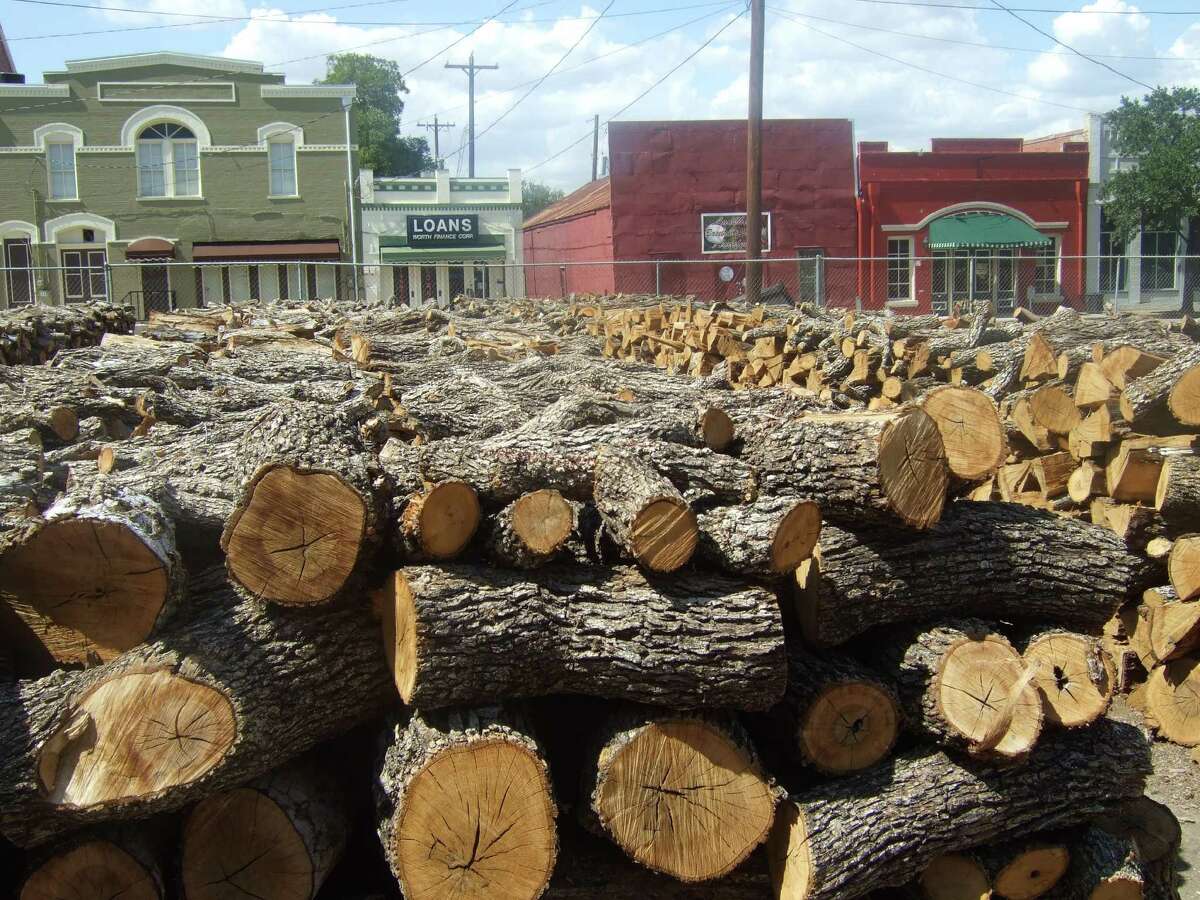 In the early days, community barbecues took place in German settlements. Sealy still plays host to the annual Millheim Harmonie Verein community barbecue. Below: Post oak is stacked at Smitty's in Lockhart.