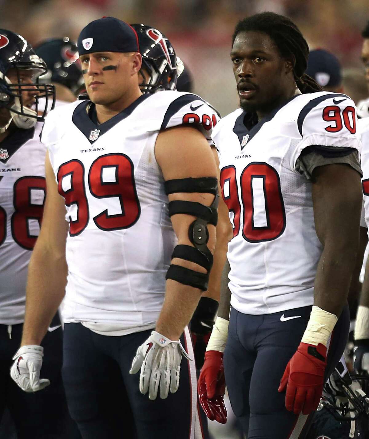 Houston Texans defensive end J.J. Watt (99) and linebacker Jadeveon Clowney (90) stand on the sidelines during the second quarter of an NFL pre-season football game against the Arizona Cardinals at University of Phoenix Stadium Saturday, Aug. 9, 2014, in Glendale, Ariz. ( Brett Coomer / Houston Chronicle )