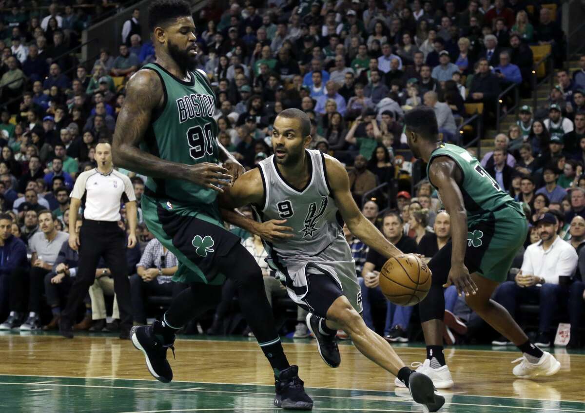 San Antonio Spurs guard Tony Parker (9) dribbles and looks to pass around Boston Celtics forward Amir Johnson (90) in the first half of an NBA basketball game, Friday, Nov. 25, 2016, in Boston. (AP Photo/Elise Amendola)
