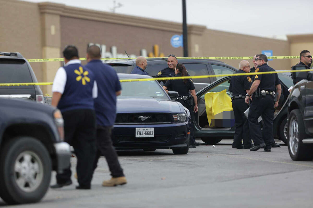 San Antonio police investigate the scene of a shooting with a person killed in the Walmart parking lot on Vance Jackson, Friday Nov. 25, 2016.             