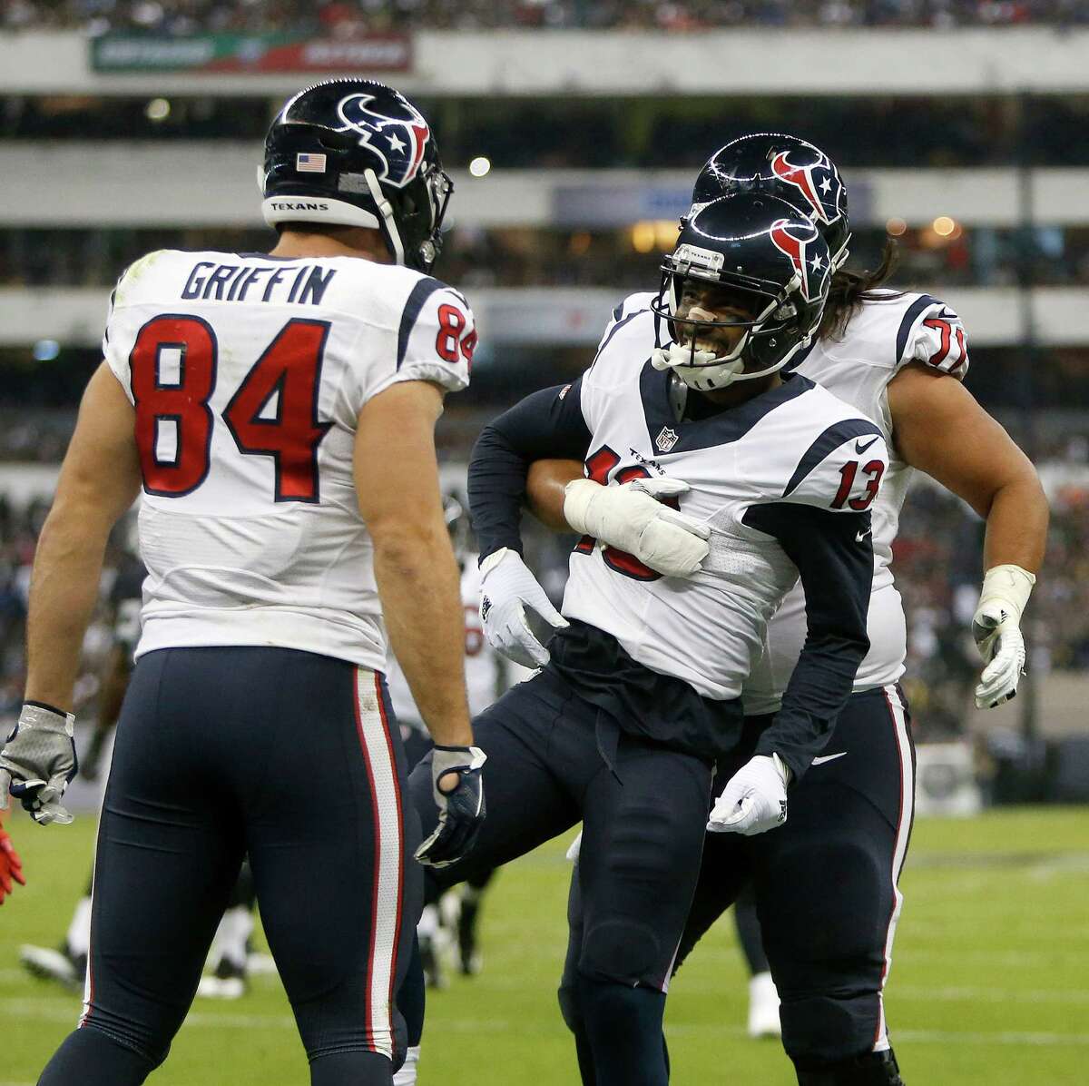 Texans wide receiver Braxton Miller (13) is all smiles as he celebrates scoring his first NFL touchdown with teammates in the second quarter Monday night.