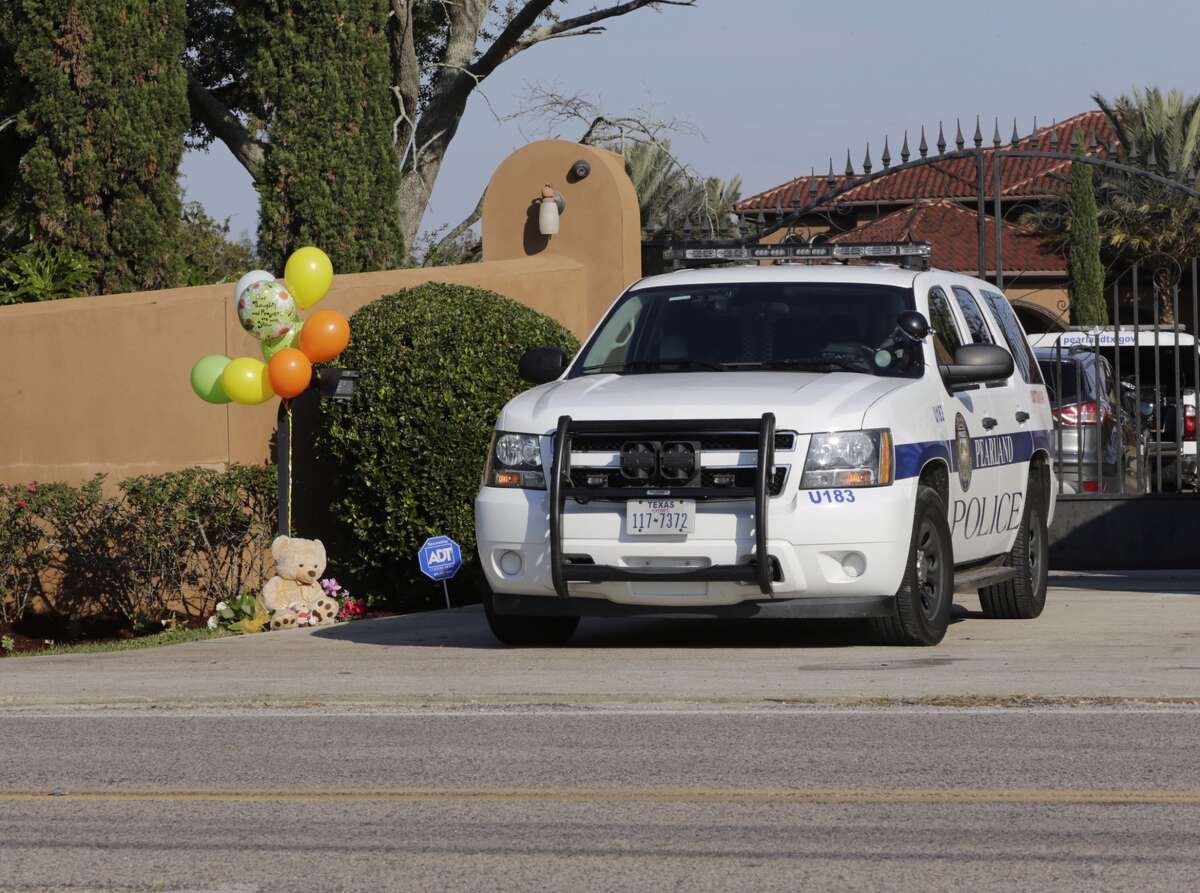 A police canine unit sits in front of the home of Marcus Camby where a makeshift memorial set up after the body of a nine year relative was found in a pond on the property Nov. 26,2016 in Pearland. ( James Nielsen / Houston Chronicle )