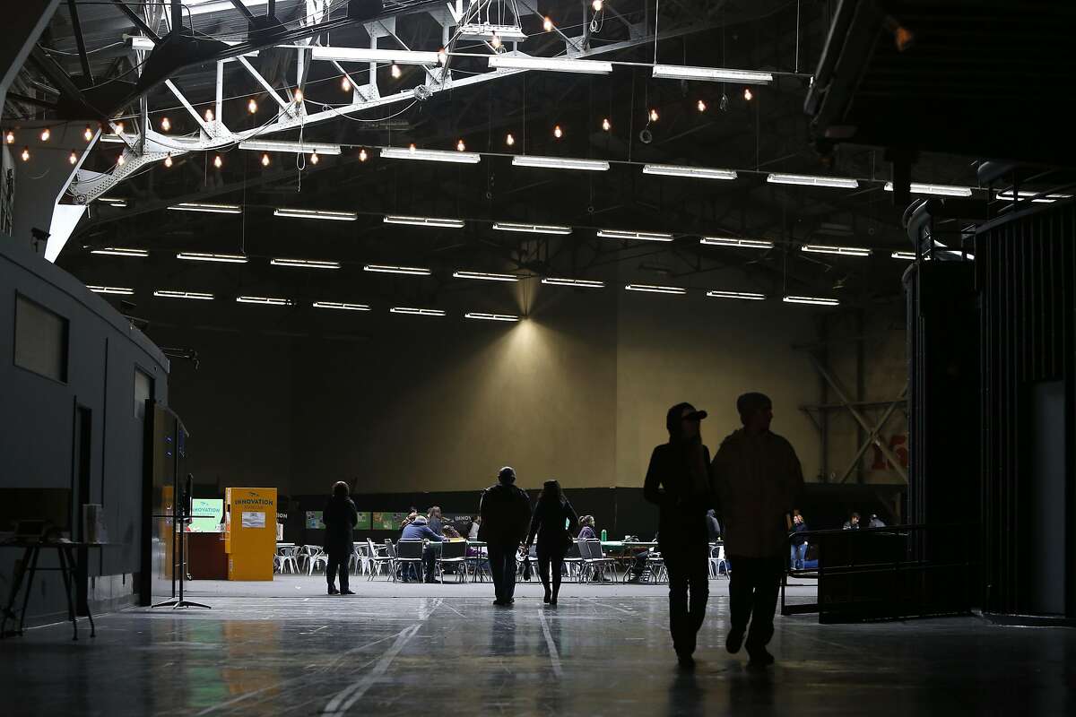 Visitors walk through the Innovation Hangar in the space which once was the home of the Exploratorium at the Palace of Fine Arts in San Francisco, Calif. on Saturday, Nov. 26, 2016.