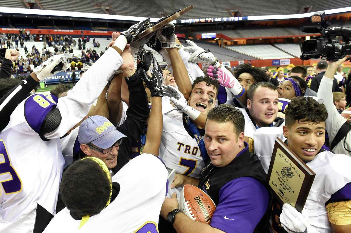 Troy hoists the first-place plaque as they celebrate their 21-20 win over Victor in the Class AA state football final on Saturday, Nov 26, 2016, at the Carrier Dome in Syracuse, N.Y. (Cindy Schultz / Times Union)