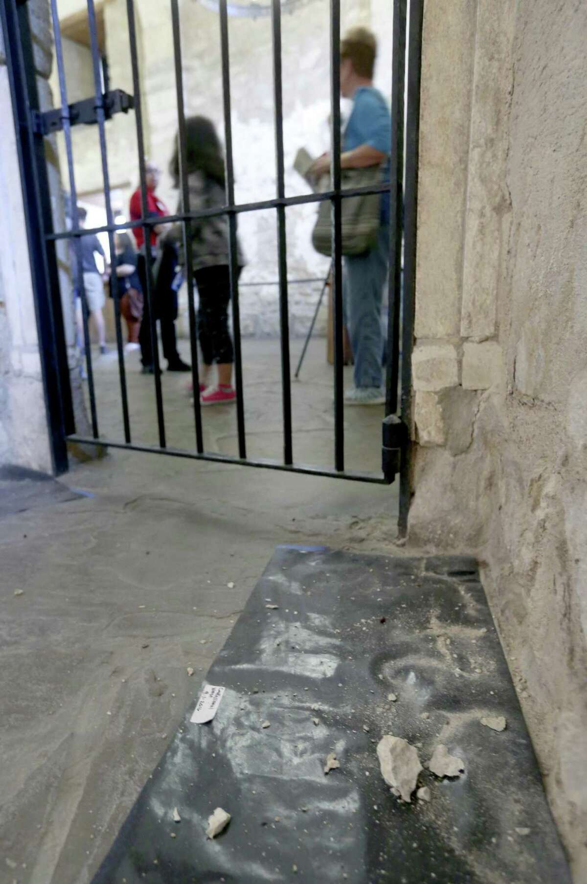 Black butcher paper lies at the base of confessional room walls Tuesday, Nov. 22, 2016, inside the Alamo church as part of a study of the deterioration the shrine's inside walls.