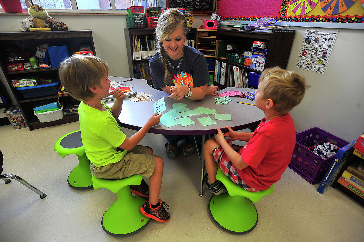 Silsbee Elementary first graders Brady Tatom, 7, (left) and Morgan Brown, 7, balance on their wobble chairs while doing a reading lesson with teacher Jill Tarkington. The chairs are part of the new furniture the school got for their new building. Photo taken Thursday, November 3, 2016 Kim Brent/The Enterprise