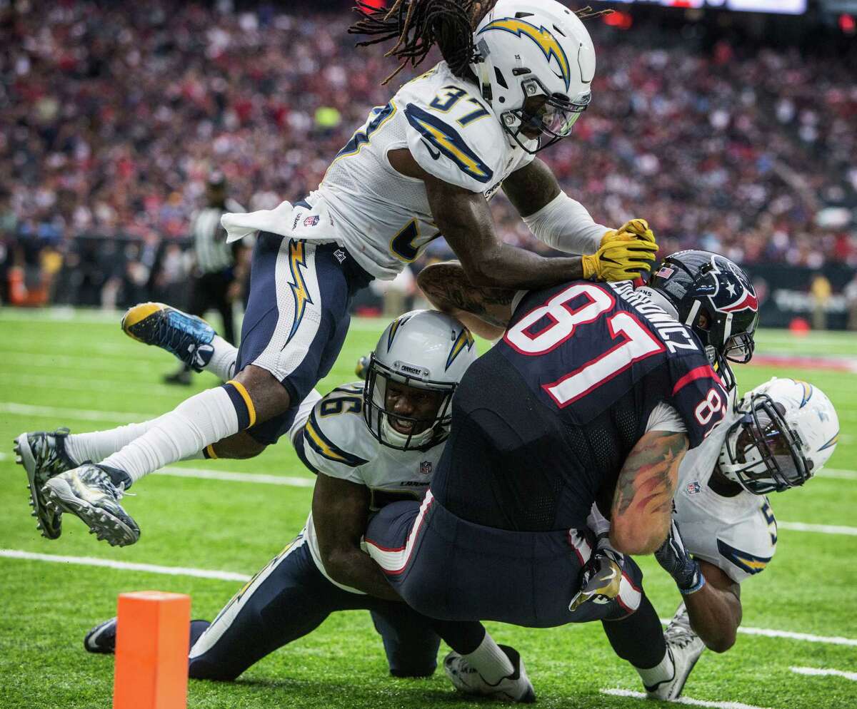 San Diego Chargers strong safety Jahleel Addae (37) and cornerback Casey Hayward (26) stop Houston Texans tight end C.J. Fiedorowicz (87) short of the goal line on third down during the fourth quarter of an NFL football game at NRG Stadium on Sunday, Nov. 27, 2016, in Houston. The Texans kicked a field goal on the next play.