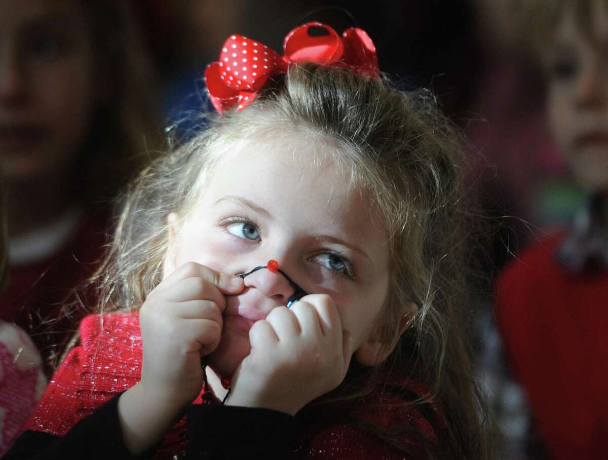 Ava Marchand, 6, of Greenwich, holds a red Christmas light over her nose while singing along to "Rudolph the Red-Nosed Reindeer" during the Greenwich Parks and Recreation Department's Brunch with Santa at the Eastern Greenwich Civic Center in Old Greenwich, Conn. Sunday, Nov. 27, 2016. More than 200 attendees enjoyed lunch catered by Citarella, Garden Catering and Starbucks with holiday music from April Armstrong before Santa's grand arrival to meet the children and listen to their Christmas wishes.