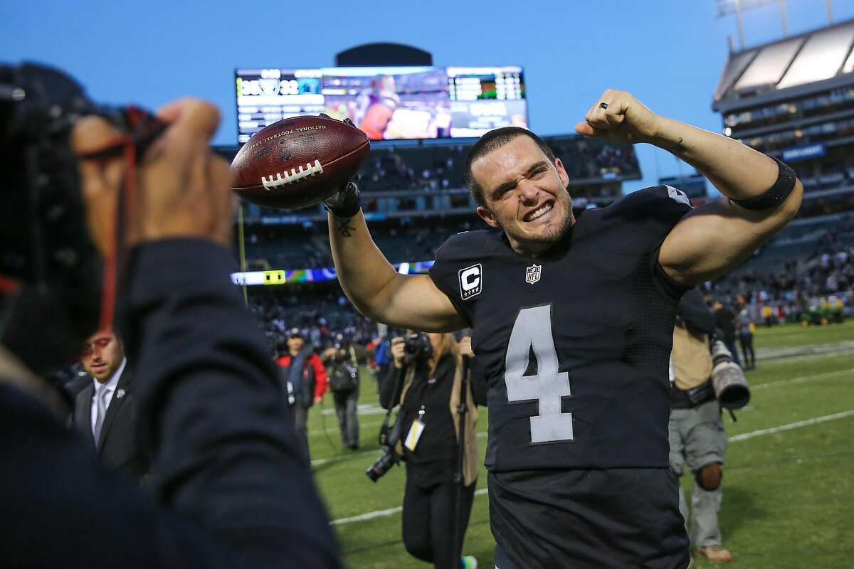 Oakland Raiders quarterback Derek Carr, #4, waves to the crowd at the end of a game against the Carolina Panthers which ended in a Raiders victory, of 35-32, at the Oakland Colliseum, in Oakland, California, on Sunday November 27, 2016. 