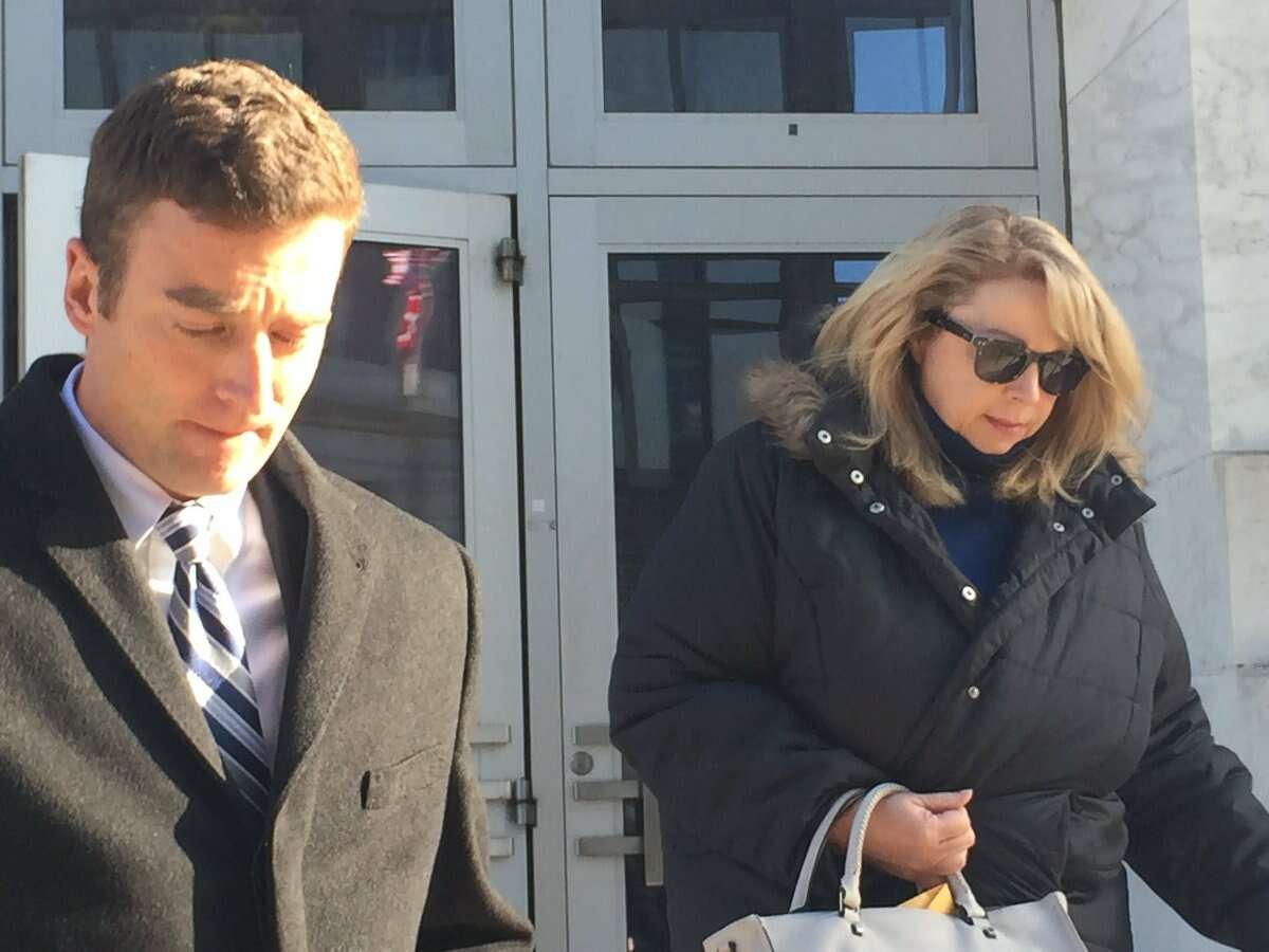 Diane L. Backis, who pleaded guilty to fraud, admitting she stole $3.1 million from her employer Cargill, leaves U.S.District Court Monday with her attorney, Scott Iseman. (Robert Gavin / Times Union)