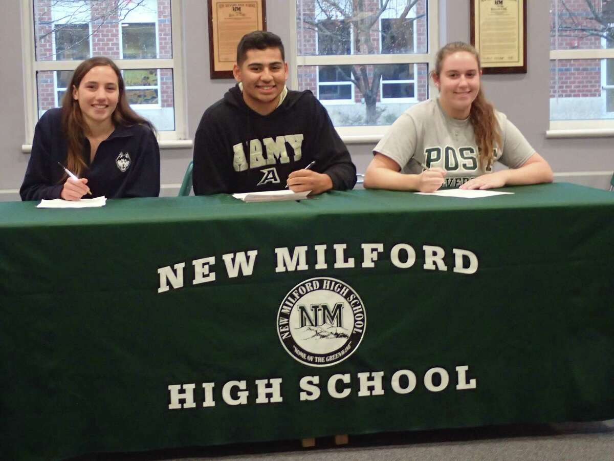Three New Milford High School athletes signed their National Letters of Intent to play their sports in college during a ceremony in the school's library on Nov. 16, 2016. Mia Nahom, left, will attend UConn and compete on the cross country and track and field teams; Noah Martinez, middle, will attend the United States Military Academy at West Point and play baseball; and Avery Kelly, right, will attend Post University and play softball.