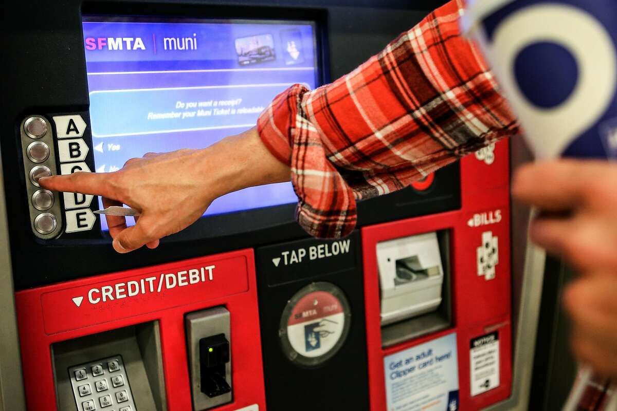 A passenger purchases a Muni ticket from a kiosk at Powell Station on Monday, November 29, 2016.