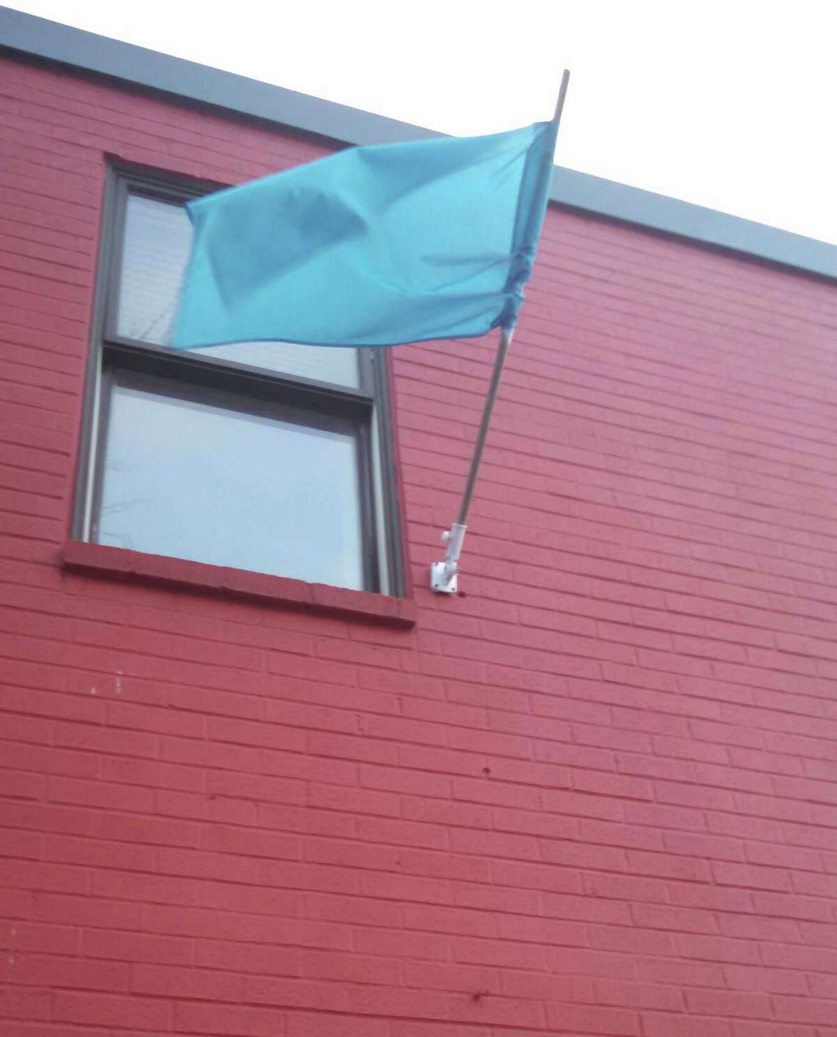 A blue flag hangs from Joseph's House & Shelter, 74 Ferry St., Troy, whenever a Code Blue is in effect for severe weather. (Photo courtesy of Joseph's House & Shelter)