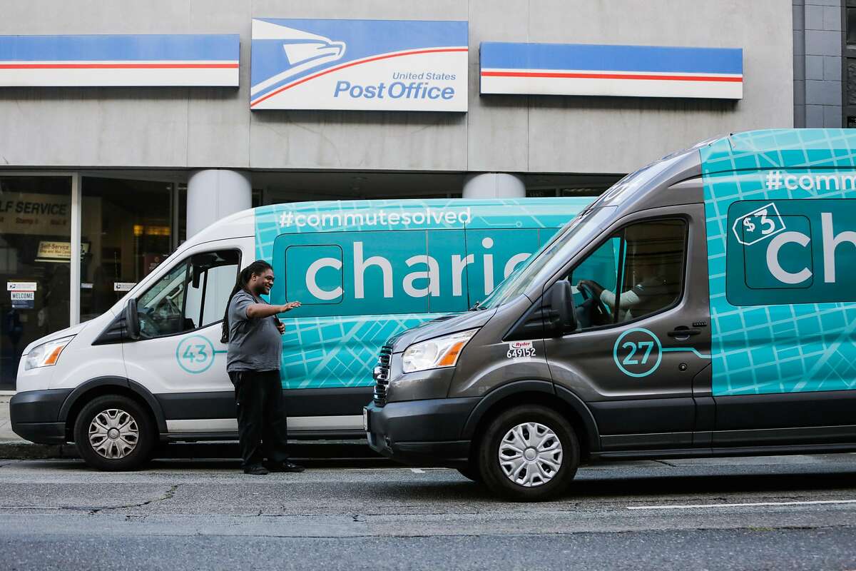 Vincent Jones (left), a driver for Chariot commuter-van service waves to another Chariot van passing by, in San Francisco, California, on Monday, November 28, 2016.
