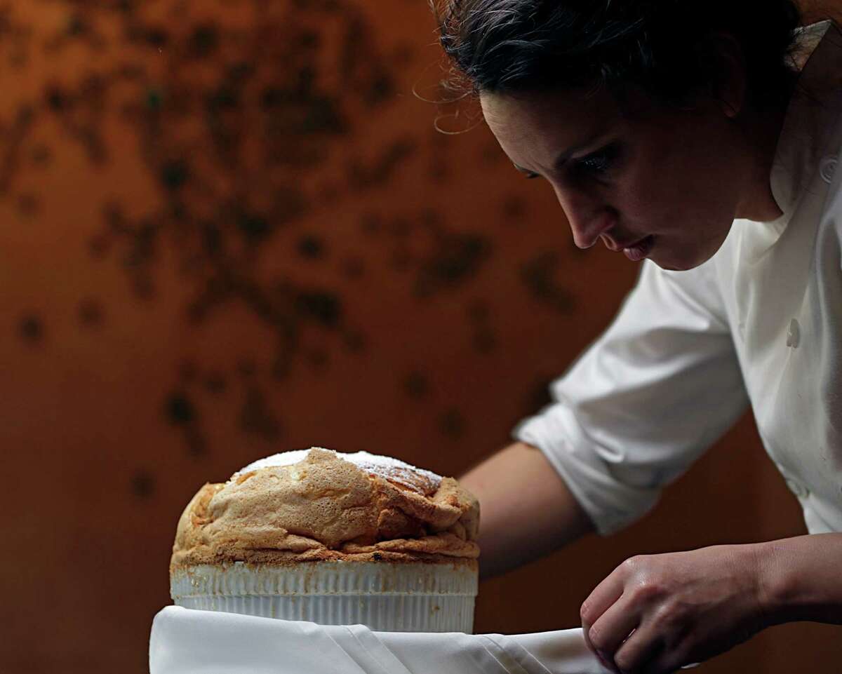 Tony's chef de cuisine Kate McLean adds the finishing touches to a Cannoli Souffle.