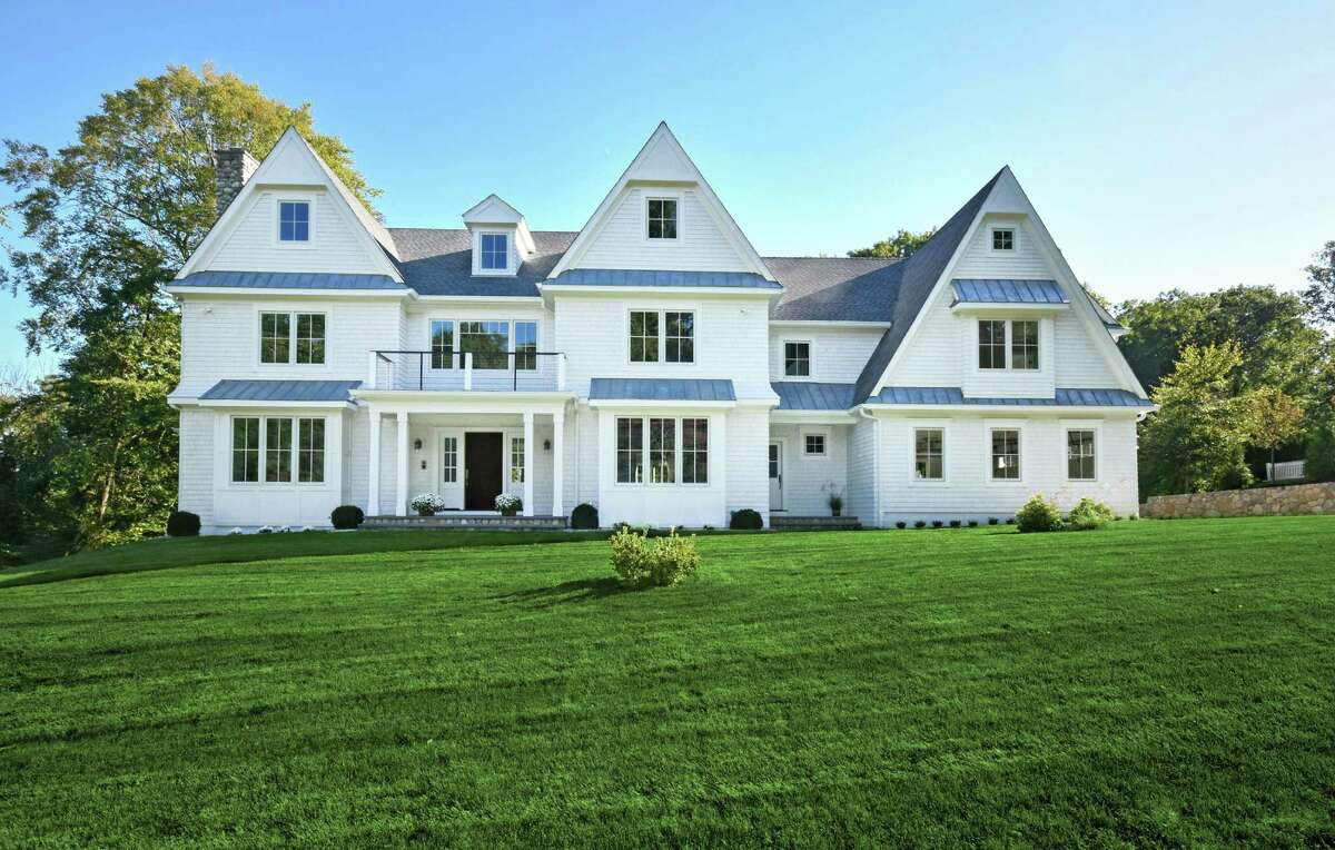 The newly constructed white colonial house at 42 Hillcrest Road was designed and built by the seasoned team of high-end residential specialists on a one-acre property.