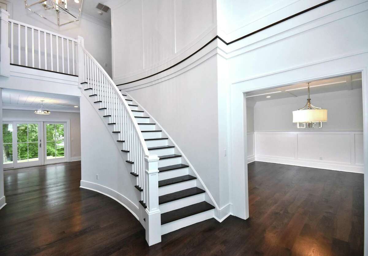 The curves of the foyer walls and the half crescent-shaped stairwell provide a graceful sophistication.