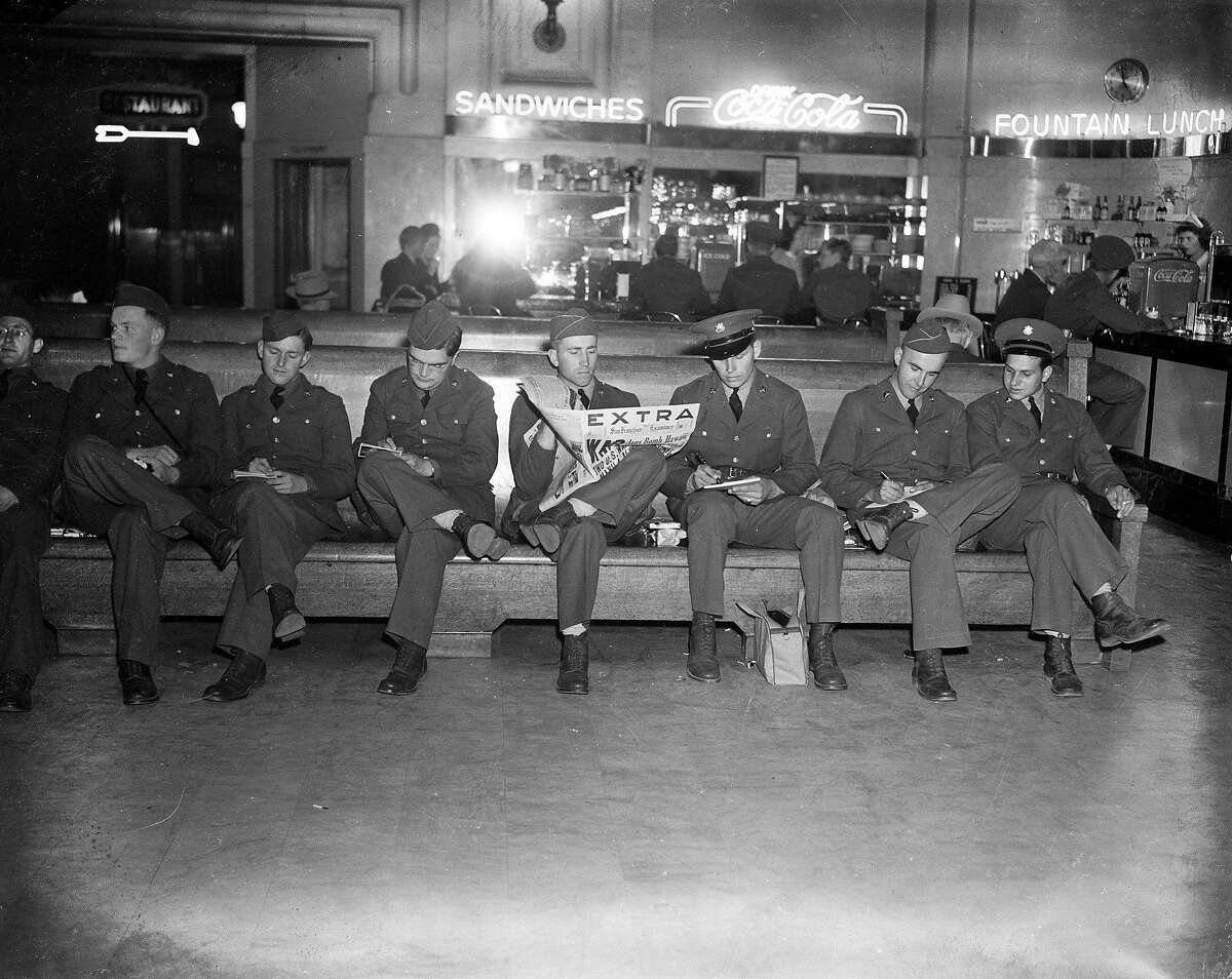 These servicemen waiting at the train station had plenty to say about, at the Japanese bombing of Pearl Harbor, December 7, 1941