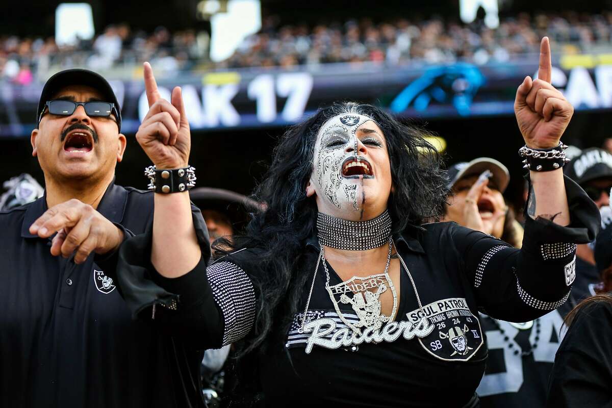 Oakland Raiders fan Eye Candee (right) cheered during a game against the Carolina Panthers which ended in a Raiders victory, of 35-32, at the Oakland Colliseum, in Oakland, California, on Sunday November 27, 2016.