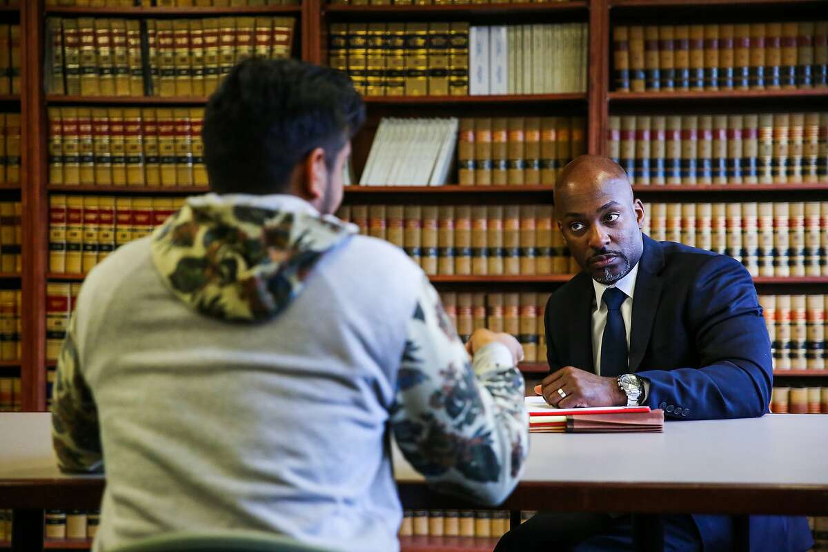 Alameda County Public Defender Brendon Wood (right) speaks with a defendant (who wished to remain anonymous) during an interview about his wrongful arrest due to a glitch in the Odyssey software, at the Alameda County Grand Jury, in Oakland, California, on Tuesday, Nov. 29, 2016.
