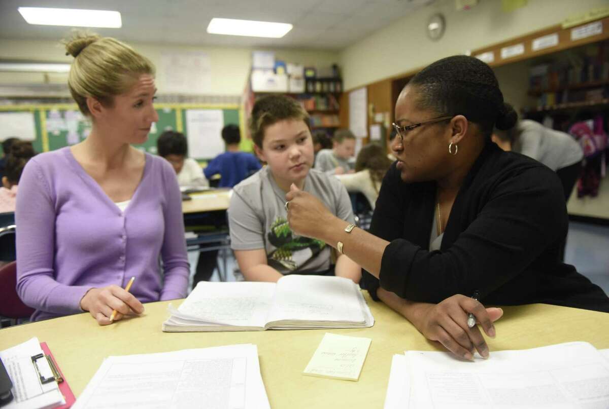 Third-grader Brayden Senft talks with third-grader teachers Christi Olzerowicz, left, and Lisa Moore during the Teachers College training session at New Lebanon School in the Byram section of Greenwich, Conn. Tuesday, Nov. 29, 2016. The Columbia University Teachers College Reading and Writing Project came to New Lebanon Tuesday for a professional development day promoting effective teaching strategies. Teachers at New Lebanon, Julian Curtiss, Cos Cob, Hamilton Avenue, and Western and Eastern Middle Schools will meet with professional developers from the Teachers College five times this year for similar workshops.