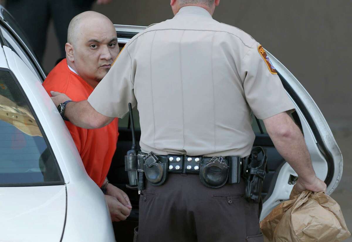Ruben "Menace" Reyes Jr. exits a police car Wednesday, Nov. 30, 2016 the John H. Wood, Jr. Federal Courthouse in San Antonio before his sentencing for his roll in killing five people. A former hitman for the Texas Mexican Mafia, Reyes was involved in killing former Balcones Heights Police Officer Julian Pesina. Ruben "Menace" Reyes Jr. admitted that he passed down orders to kill Pesina and killed four other fellow gang members as part of the gang's efforts to control the drug market here through extortion and violence.