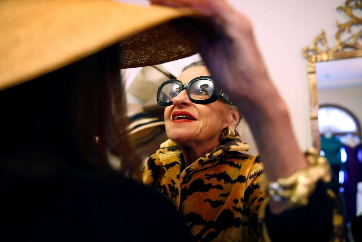 Joy Bianchi helps Allison Thompson try on a hat at Helpers House of Couture in San Francisco, Calif., on Sunday, January 17, 2016.