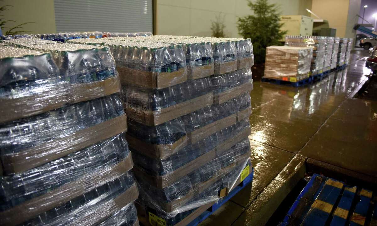 Donations of water and fluids arrive for residents, displaced by the mandatory evacuations caused by the wildfires, gather at Rocky Top Sport World on US321 just outside of Gatlinburg, Tenn., Wednesday, Nov. 30, 2016. (Michael Patrick/Knoxville News Sentinel via AP)