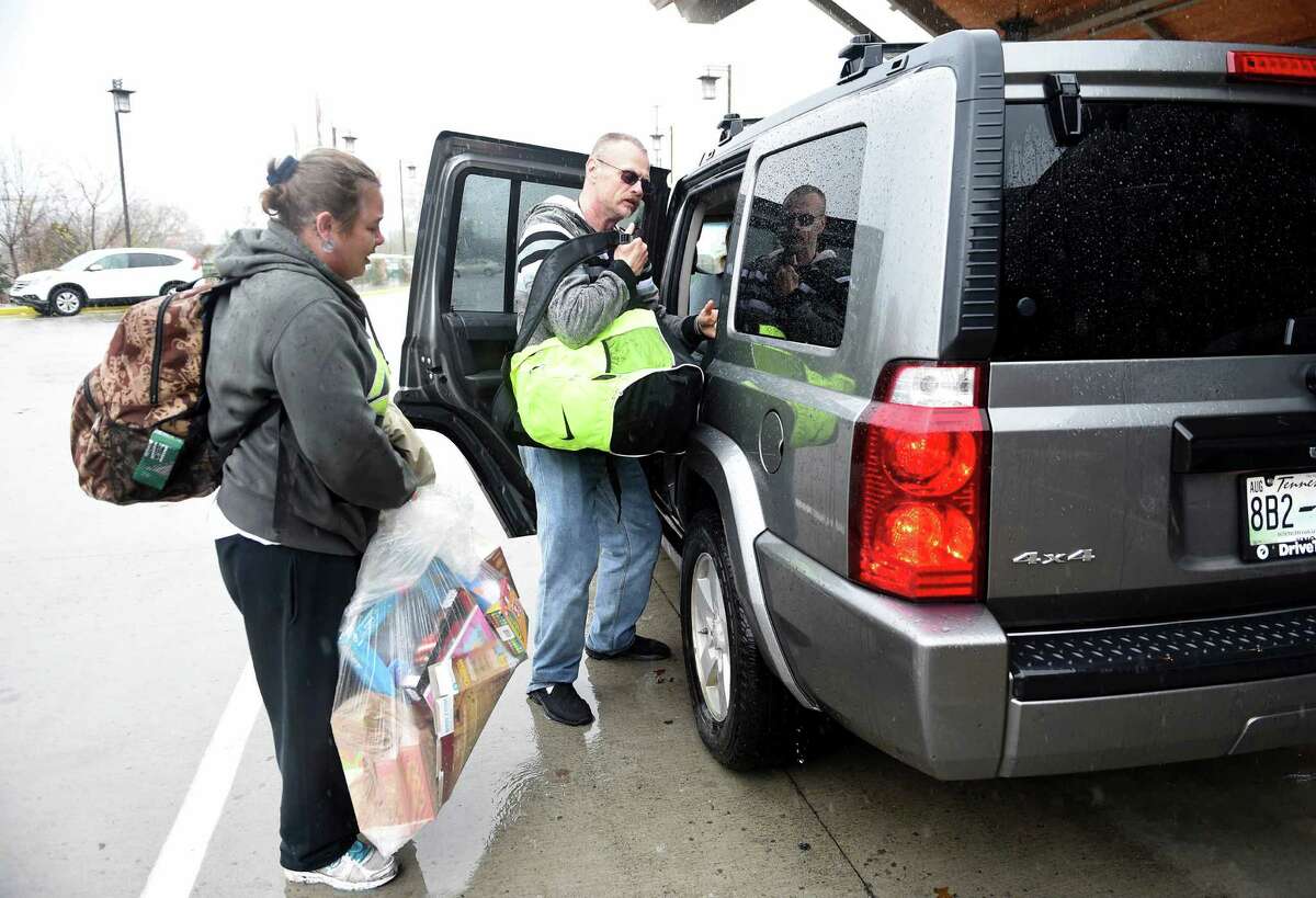 Jasmine Hurst, left, and Charles Britton load up a car to be taken to an area motel from the LeConte Center Wednesday, Nov. 30, 2016, in Pigeon Forge, Tenn., which has been serving as a Red Cross shelter since the wildfires in Pigeon Forge and Gatlinburg. (Amy Smotherman Burgess/Knoxville News Sentinel via AP)