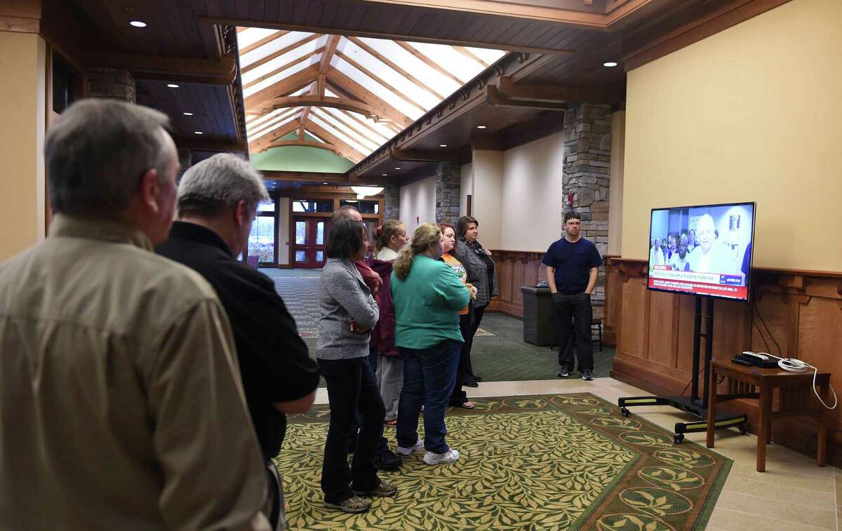 People gather to watch a press conference given by officials at the LeConte Center Wednesday, Nov. 30, 2016, in Pigeon Forge, Tenn., which has been serving as a Red Cross shelter since the wildfires in Pigeon Forge and Gatlinburg. (Amy Smotherman Burgess/Knoxville News Sentinel via AP)