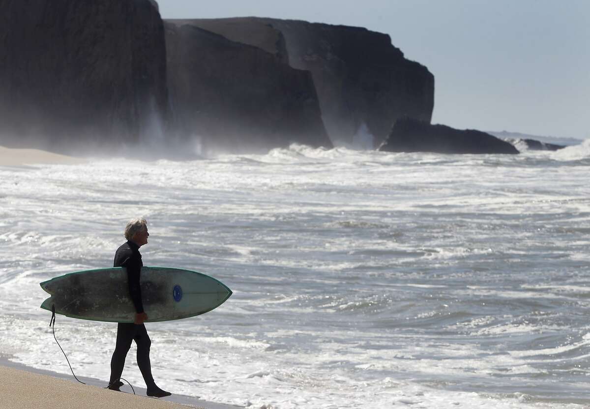 Mark Massara, one of the attorneys representing the Surfrider Foundation, is ready to surf at Martin's Beach in Half Moon Bay, Calif. on Thursday, Sept. 25, 2014, one day after a judge ordered landowner Vinod Khosla to unlock a private gate and allow public access to the beach.