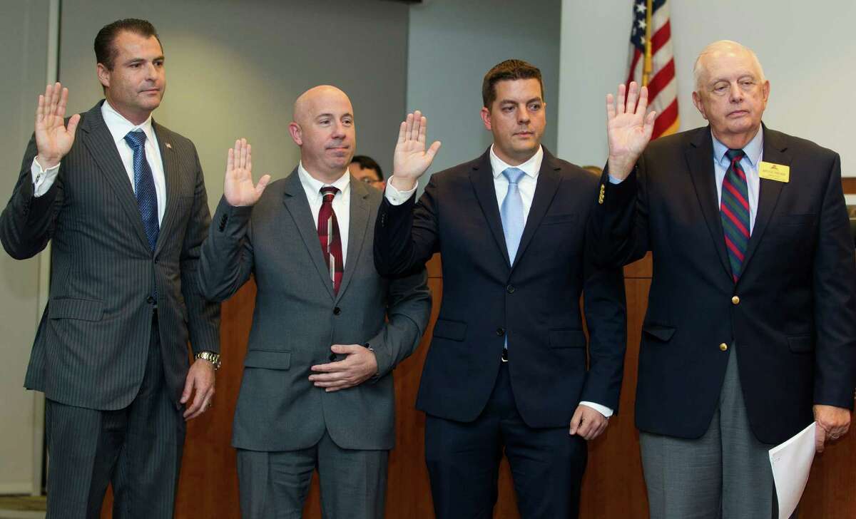 Gordy Bunch, John Anthony Brown, Brian Boniface and Bruce Rieser are sworn into office during The Woodlands Township's board meeting Wednesday, Nov. 30, 2016, in The Woodlands.