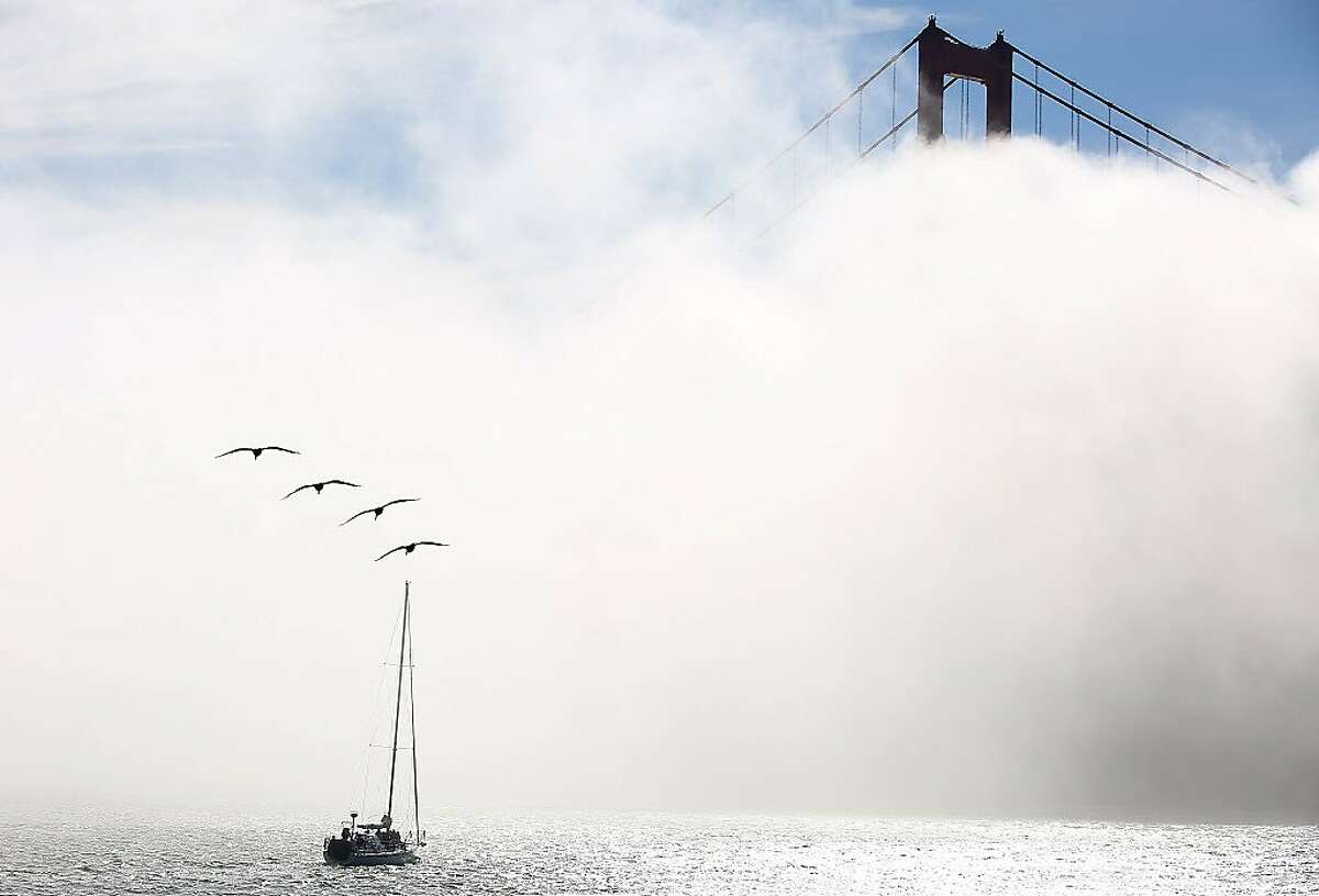 Fog rolls over the bay at Golden Gate Bridge. Could skywriting be seen?