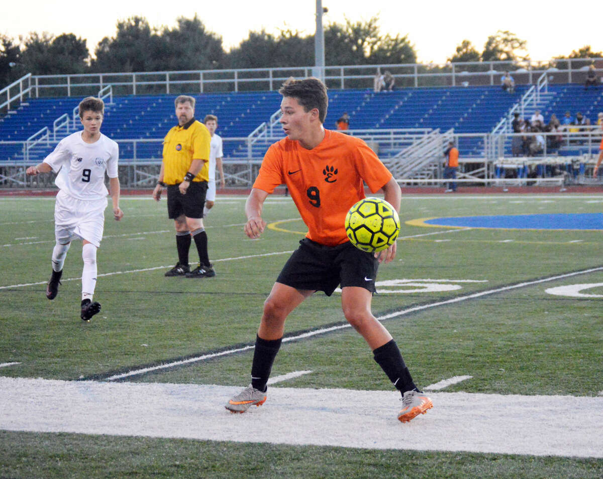 Edwardsville junior midfielder Kyle Wright prepares to play a ball at midfield late in the first half.